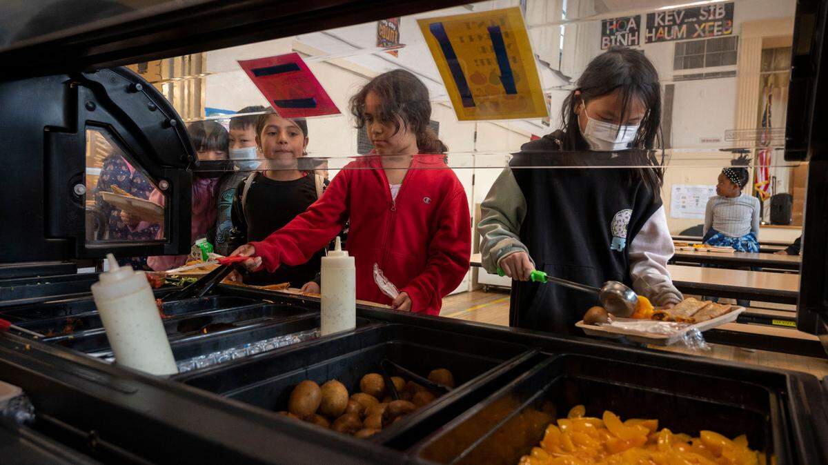 School kids use a self-service bar to get their lunch at Oak Ridge Elementary School in Oak Park on Wednesday, Feb. 22, 2023. Many families would struggle without free school meals.