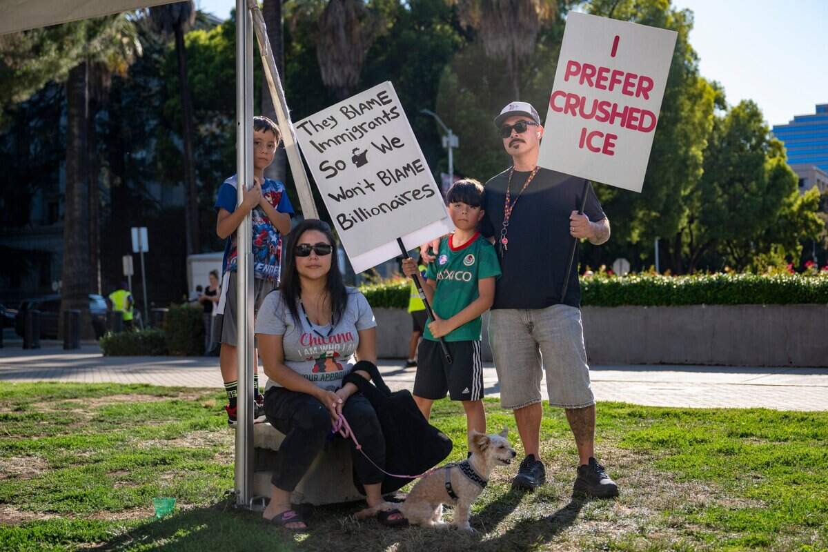 Alonzo, 7, left, Rosa, center left, Romeo, 10, center right, and Jared Valadez, right, demonstrate at the state Capitol during the “Good Trouble” protest in Sacramento on Thursday. The protest, in opposition to President Donald Trump is named after former Rep. John Lewis and his legacy of activism.