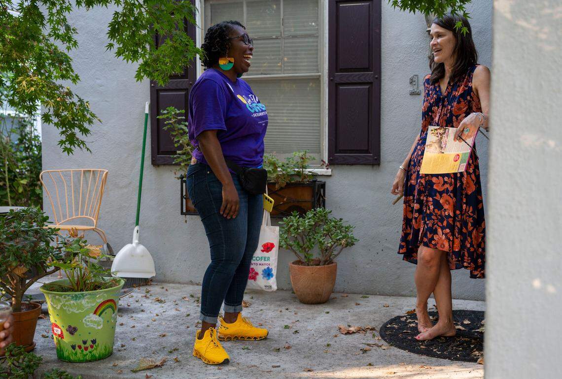 Mayoral candidate Flo Cofer talks with Yoly Stroeve on her front porch while canvassing the Land Park neighborhood for voter support Tuesday.