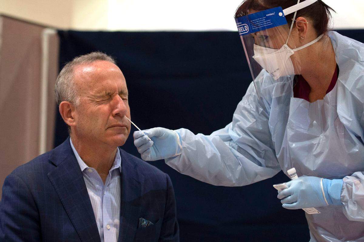 Sacramento Mayor Darrell Steinberg winces as he gets tested for COVID-19 by public health nurse Angie Butters on May 15, 2020.