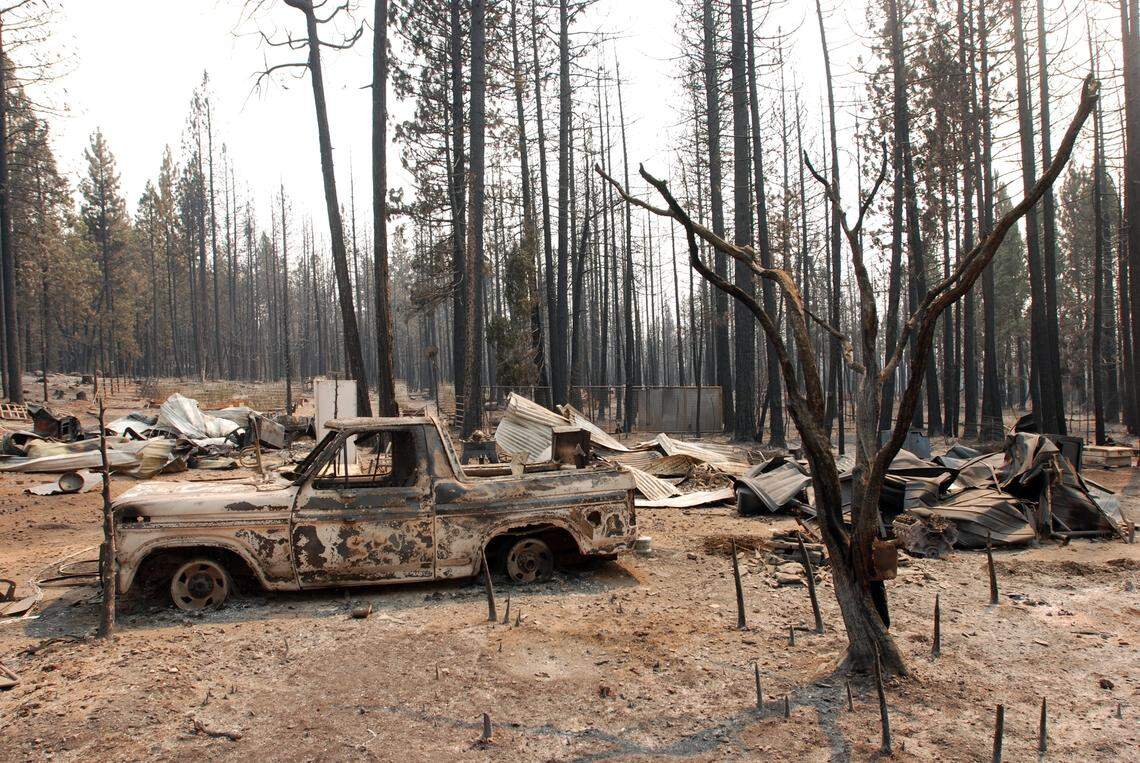 A damaged truck sits among other remains at a rural house site outside the community of Manton – just south of Shingletown – after it was burned by the Ponderosa Fire in August 2012.