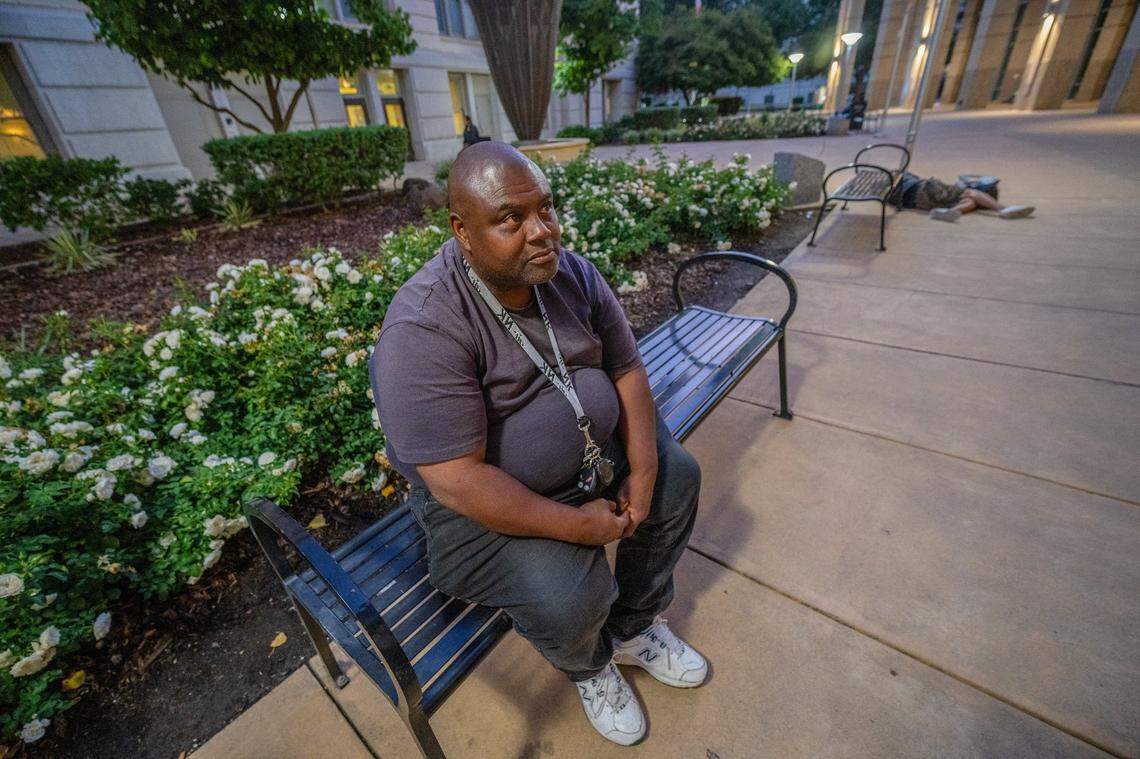 Clint Washington, 52, who has been homeless for the past four years, sits on a bench on earlier this month waiting for 9 p.m. so he can sleep outside Sacramento City Hall. “It’s safe,” he said. “They’ve got security and there are more people around, so if something happens somebody can get help.”