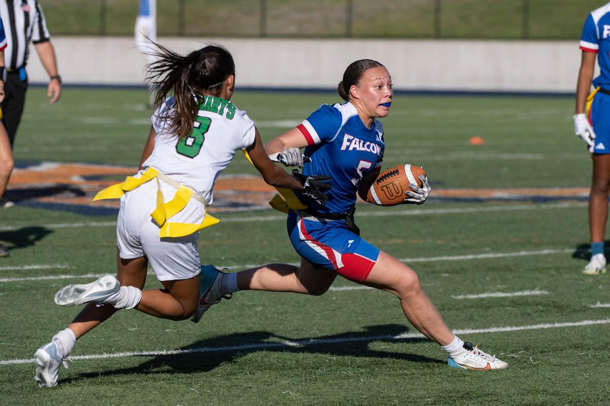 The Christian Brothers Falcons’ Aleyah Harmon (5) runs the ball before the St. Mary’s Rams Larissa Hackley (44) pulls her flag in the second half of the CIF Sac-Joaquin Division II flag football championship on Saturday, Nov. 4, 2023, at Cosumnes River College in Sacramento.