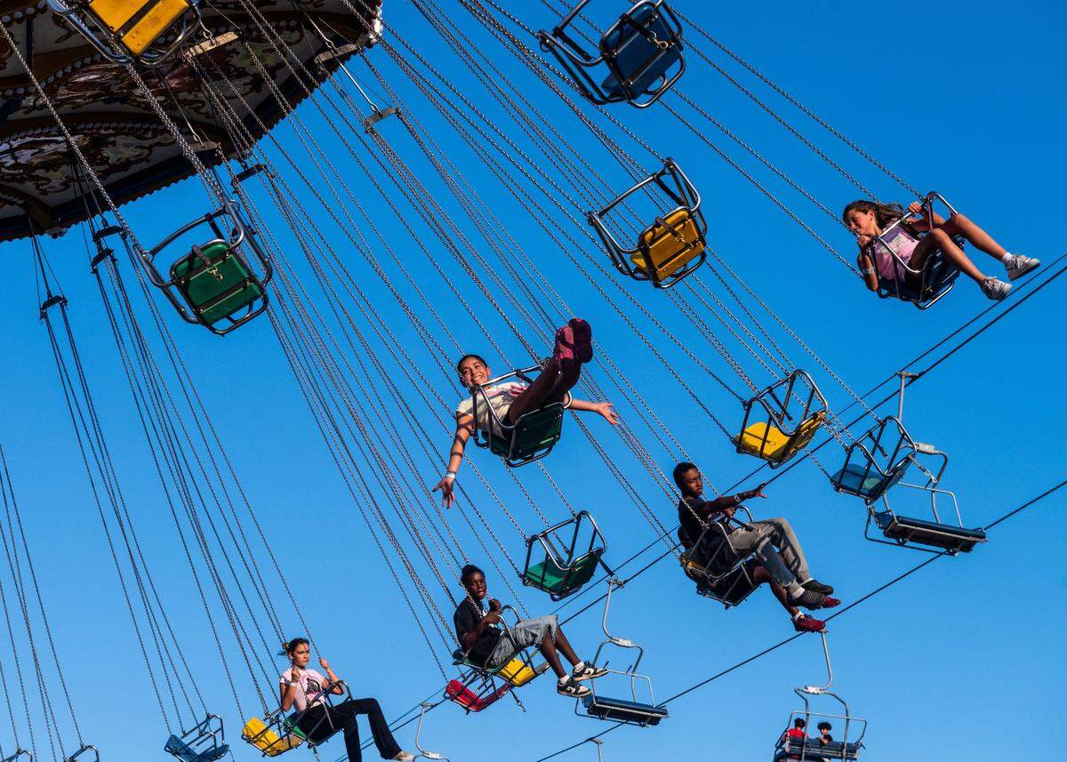 Fair-goers ride the chair swing ride at the California State Fair on July 11.