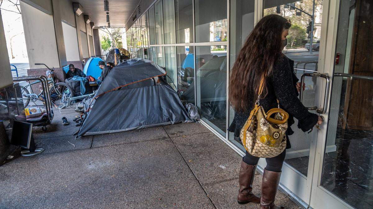 “This is the first time I can open the door without asking people to move,” says Alma Perez as she opened her salon for city inspectors to see the smoke damage inside in Sacramento on Wednesday, March 24, 2021. City Hall Garage, where the homeless had been permitted to park, was damaged by a fire caused by a van.