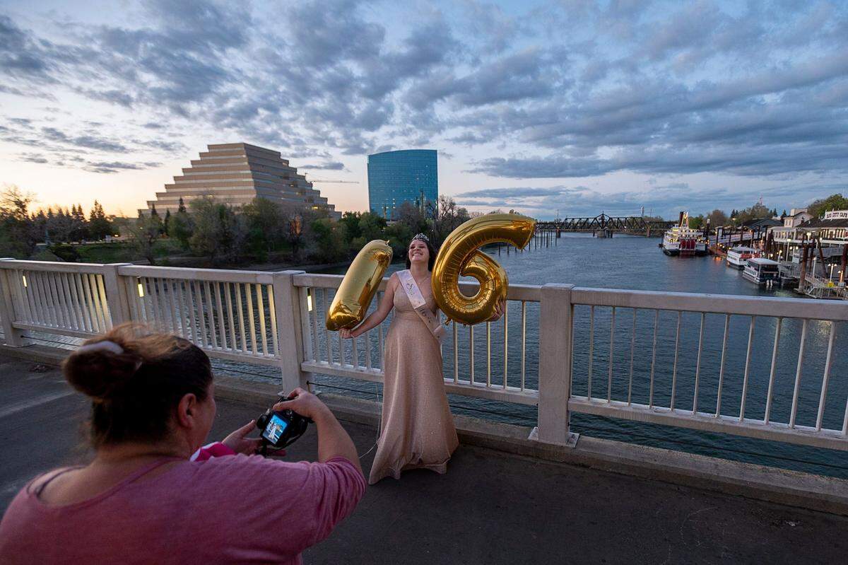 Destiny Rogers of West Sacramento takes a Sweet 16 birthday photo on Sacramento’s Tower Bridge with her mother, April Thornbrough, on Tuesday evening, March 31, 2020. The two took a break from staying at home because of the coronavirus pandemic to get some fresh air and take a celebration photo at one of her favorite outdoor locations.