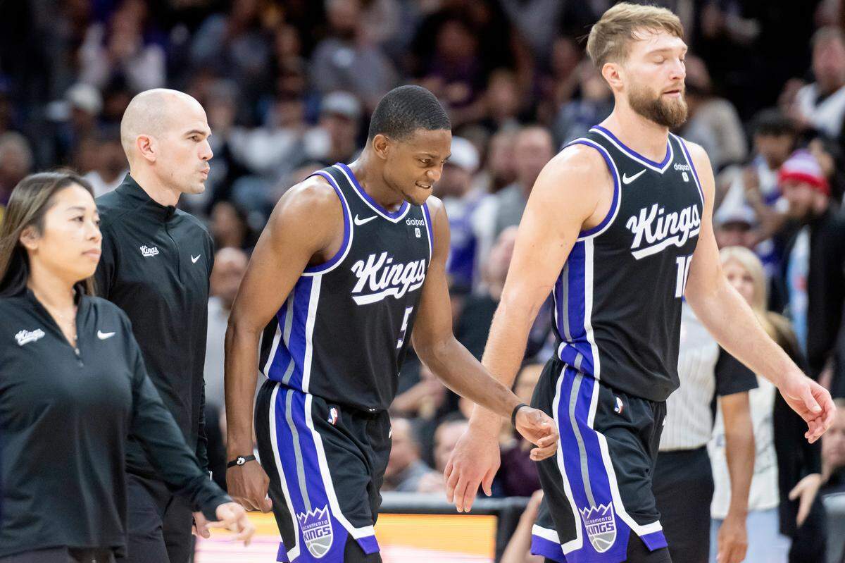 Sacramento Kings guard De’Aaron Fox (5) walks to the locker room after being fouled by Los Angeles Lakers guard Gabe Vincent (7) in the second half on Sunday.