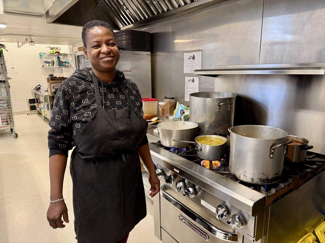 Naija Cuisine proprietor Adeola Adedayo tends her station in a commercial kitchen inside Pioneer Church on L Street. 