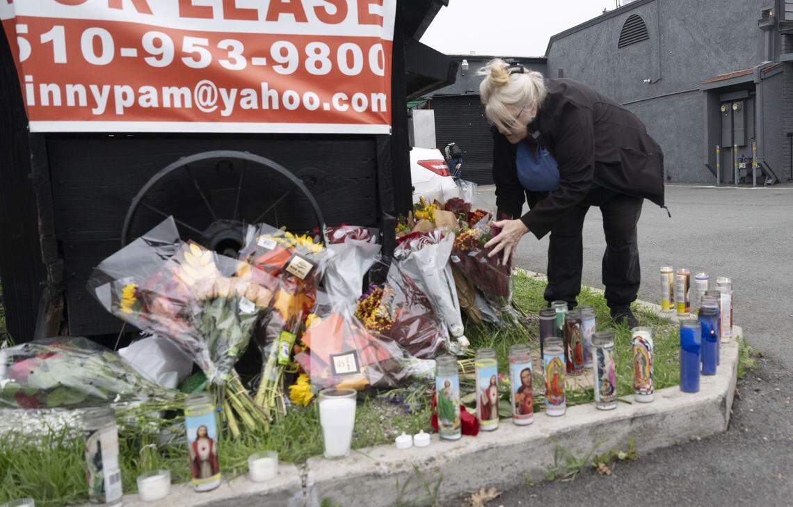 Stockton resident Carolyn Tahod delivers flowers on Monday to a memorial at the Lucile Avenue building just outside the city of Stockton where a mass shooting took place over the weekend.