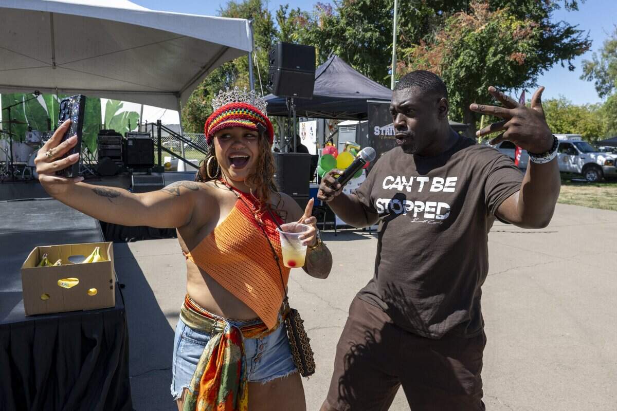 Banana queen Siat and M.C. Russell Cummings entertain the crowd at the Banana Festival in Land Park on Saturday, Aug. 15, 2026.