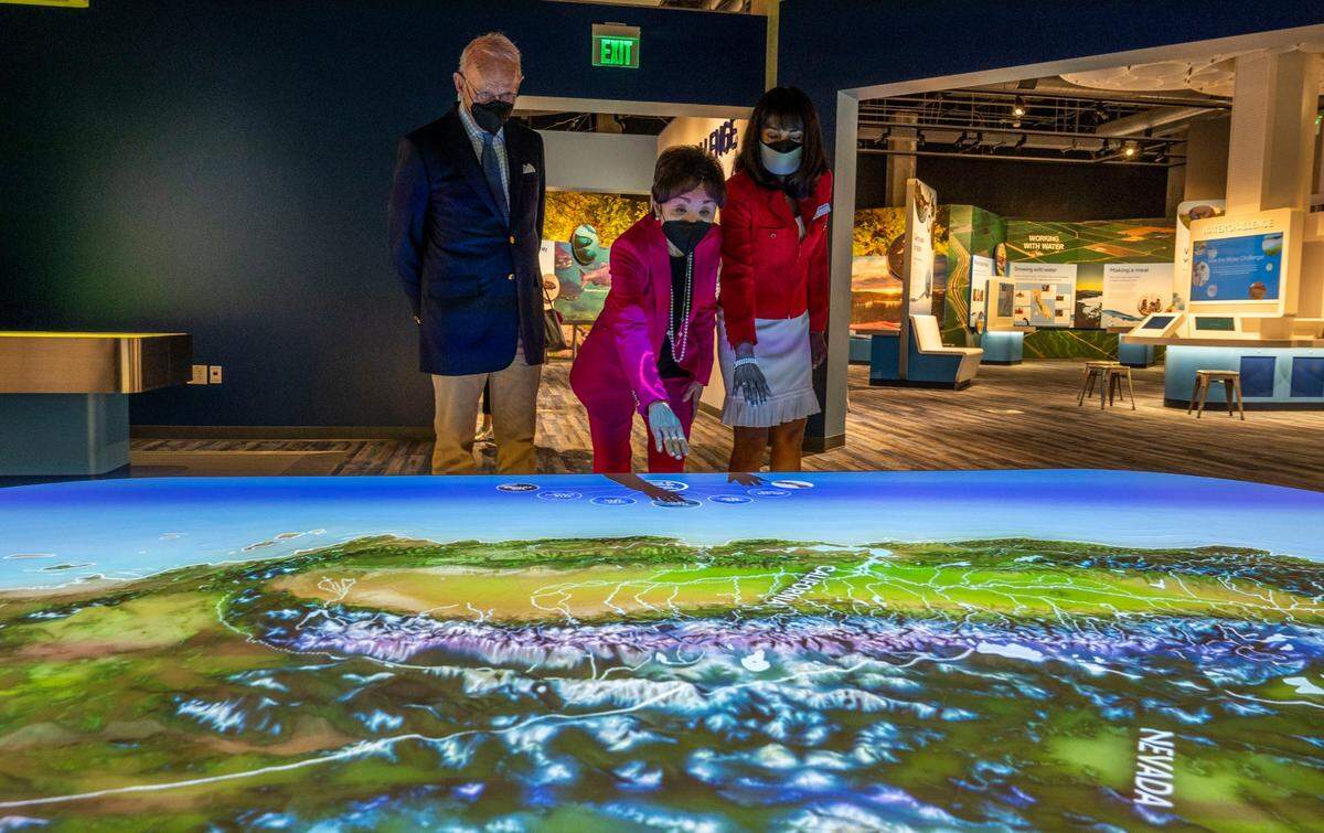 Shahnaz Van Deventer, right, director of marketing at the SMUD Museum of Science and Curiosity, shows a weather exhibit to U.S. Rep. Doris Matsui, center, and her husband Roger Sant.