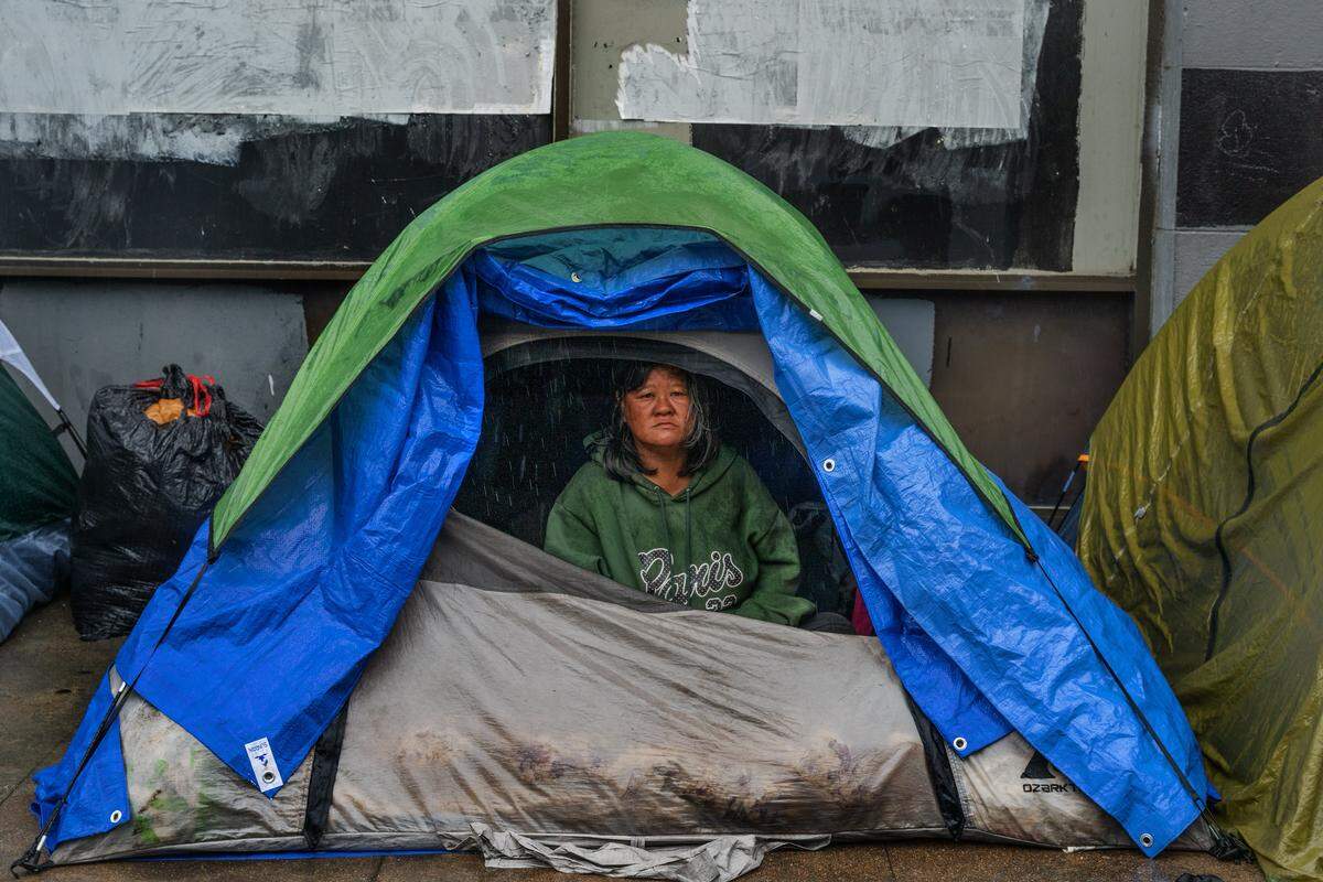 Mane “Jessica” Davila stares out of her tent on a rainy day on 10th Street in Sacramento on Wednesday, Nov. 5, 2025. “I went to City Hall to speak, and they don’t really care. They treat us like trash. We are human beings too,” said Davila. “There’s no housing yet. Until we get into a tiny home, there is no update or anything right now.”