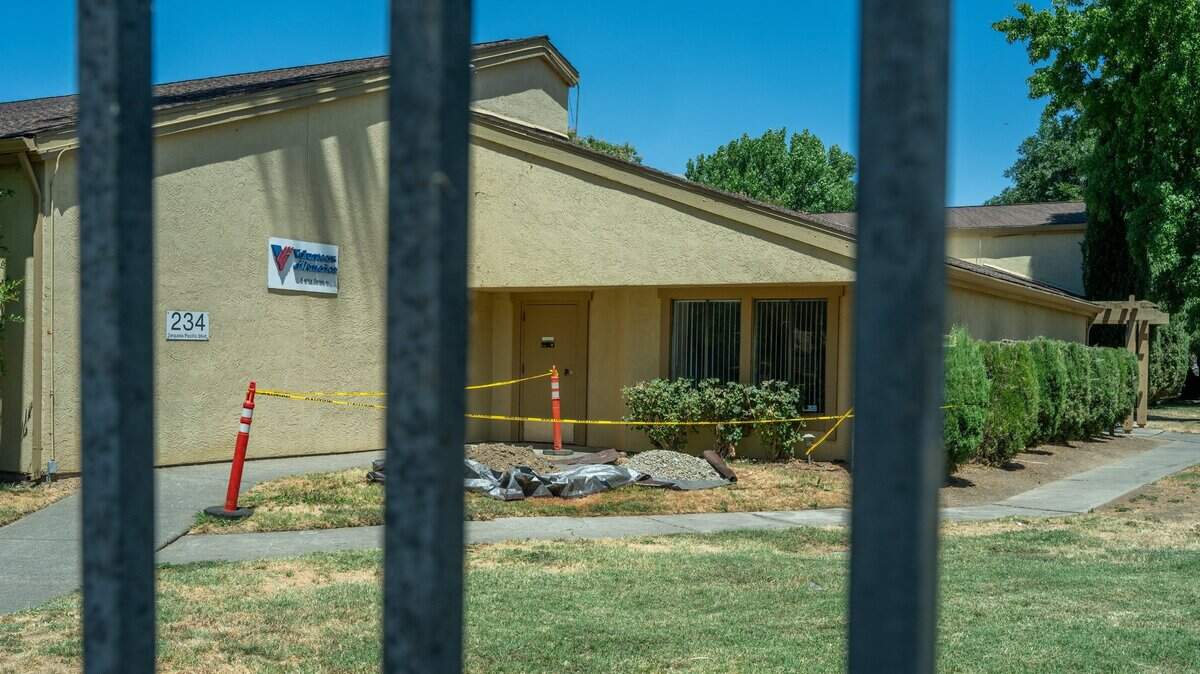 Tape surrounding a construction area is seen behind a locked iron gate at Volunteers of America’s Residential Family Shelter for the unhoused on Tuesday. The facility is going to be closing Sept. 7. Volunteers of America has put over $1 million into the property over the years, funded by donations, said Christie Holderegger, a VOA spokeswoman.