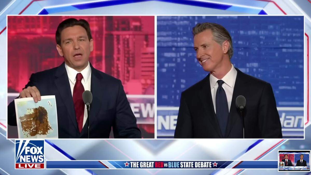 Florida Gov. Ron DeSantis holds up the “San Francisco poop map” during his debate with California Gov. Gavin Newsom on Fox News on Thursday.