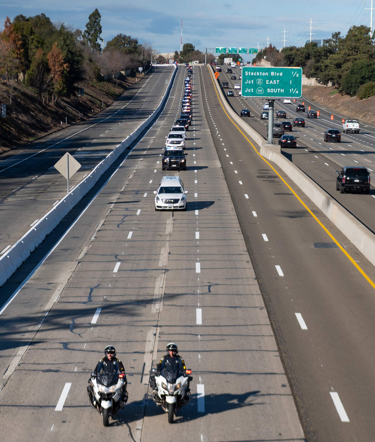 3. More than a hundred vehicles joined the procession for Sacramento County Sheriff’s deputy Adam Gibson from the county coroner’s office to a Folsom funeral home on Friday, Jan. 22, 2021. Formal services on Wednesday for Gibson, who was killed along with K-9 Riley in a shooting at Cal Expo, will be limited to law enforcement only due to COVID-19 restrictions. There will be a law enforcement procession following the services to accompany Gibson to a cemetery in Sacramento County for interment.
