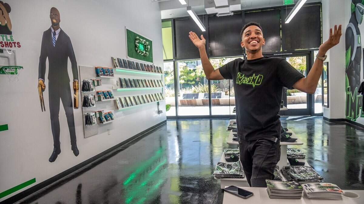 Brent Trayce Sands, creator of Impound Comics, reacts after making a basket inside his new store in DoCo on Monday August 2, 2021, in Sacramento. People who make a purchase are given a change to make a basket and win a free prize.