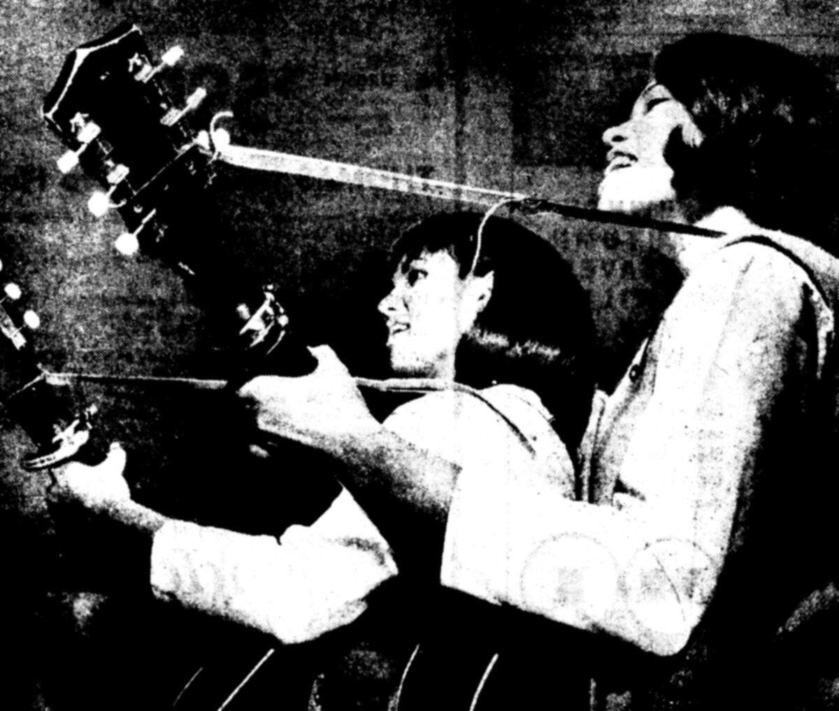 Jean and June Millington play their instruments in a photograph accompanying a 1964 Bee article on high school surf bands.