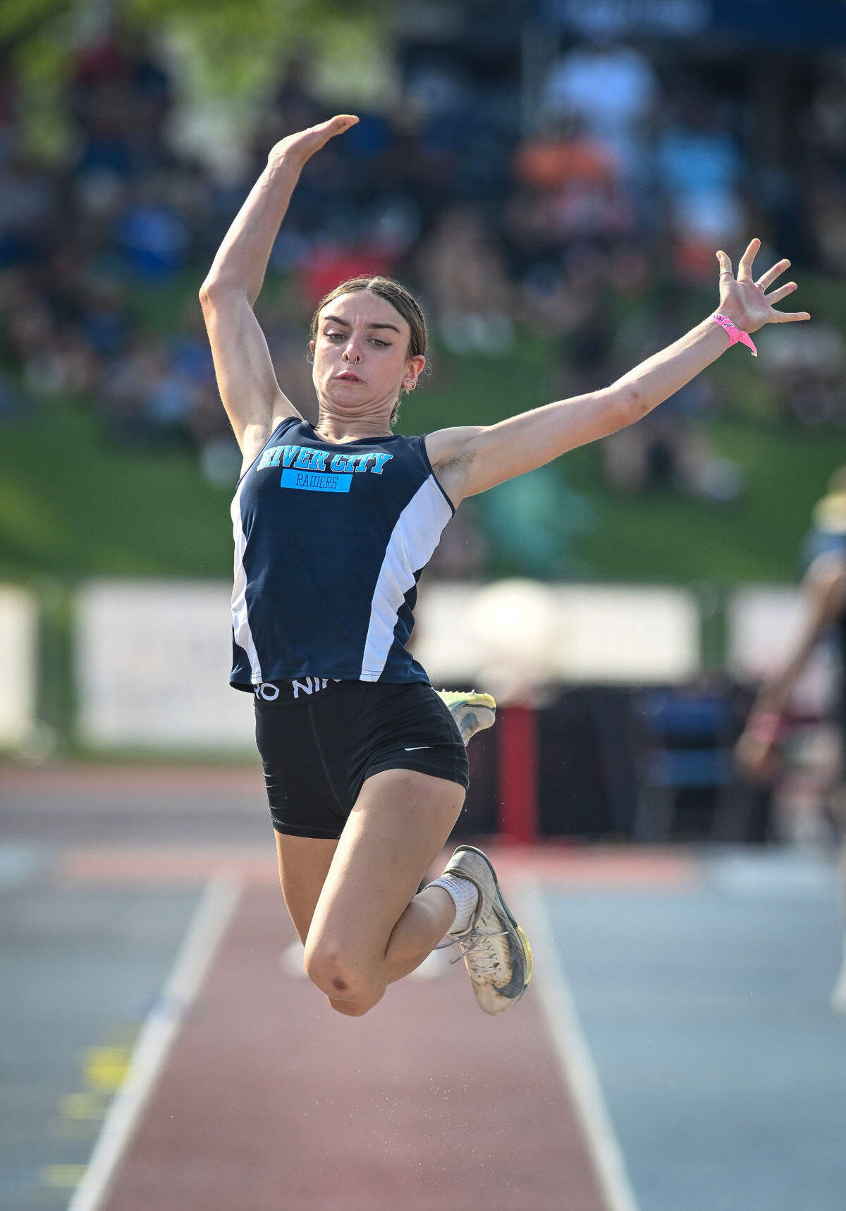 Brooke White of River City High School of West Sacramento competes in the long jump at the track and field championships on Saturday in Clovis. She placed second in the event with a jump of 20-8 3/4, which tied transgender athlete AB Hernandez.
