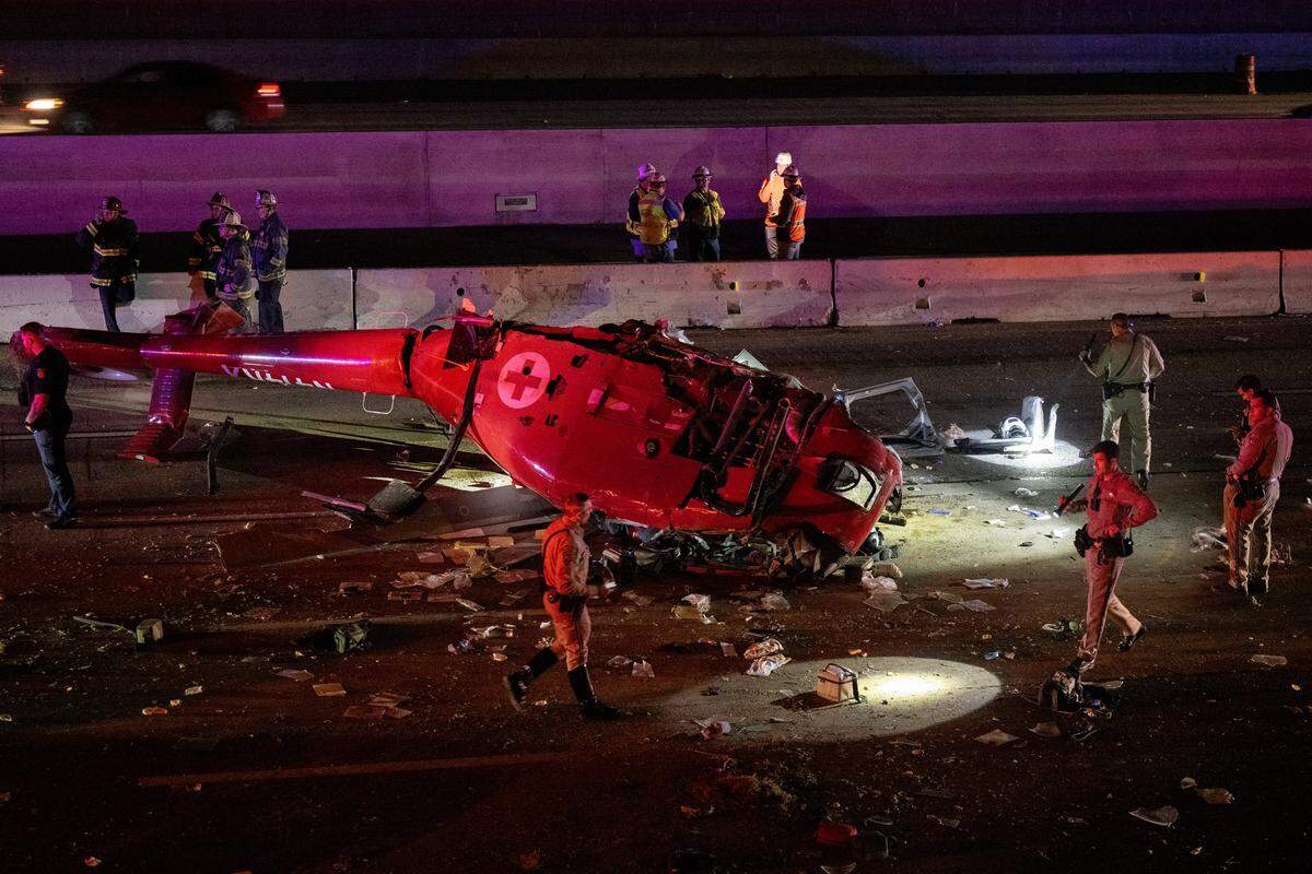 A medevac helicopter with three people crashed on eastbound Highway 50 near 44th Street on Monday, Oct. 6, 2025, in Sacramento. The aircraft was split down the middle — exposing its bungled interior — as CHP investigators used flashlights along the shoulder, searching for debris.