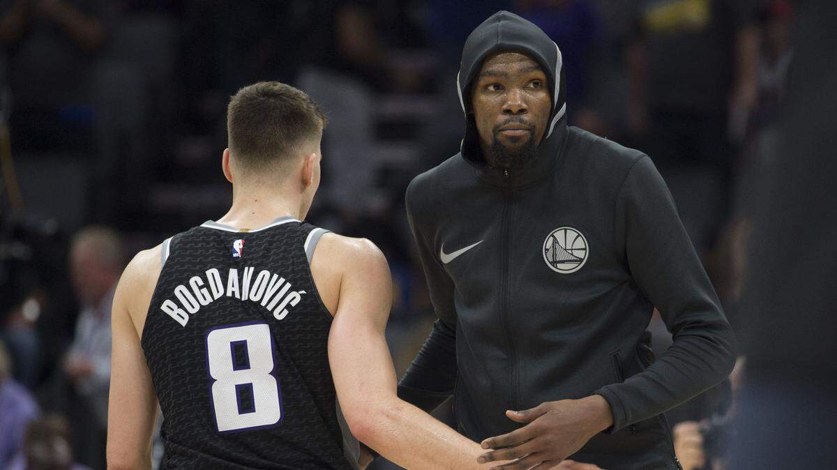 Kings guard Bogdan Bogdanovic greets Golden State Warriors forward Kevin Durant after a game Feb. 2 at Golden 1 Center. The teams will meet Oct. 5 in Seattle for a preseason game which will be nationally televised on ESPN.