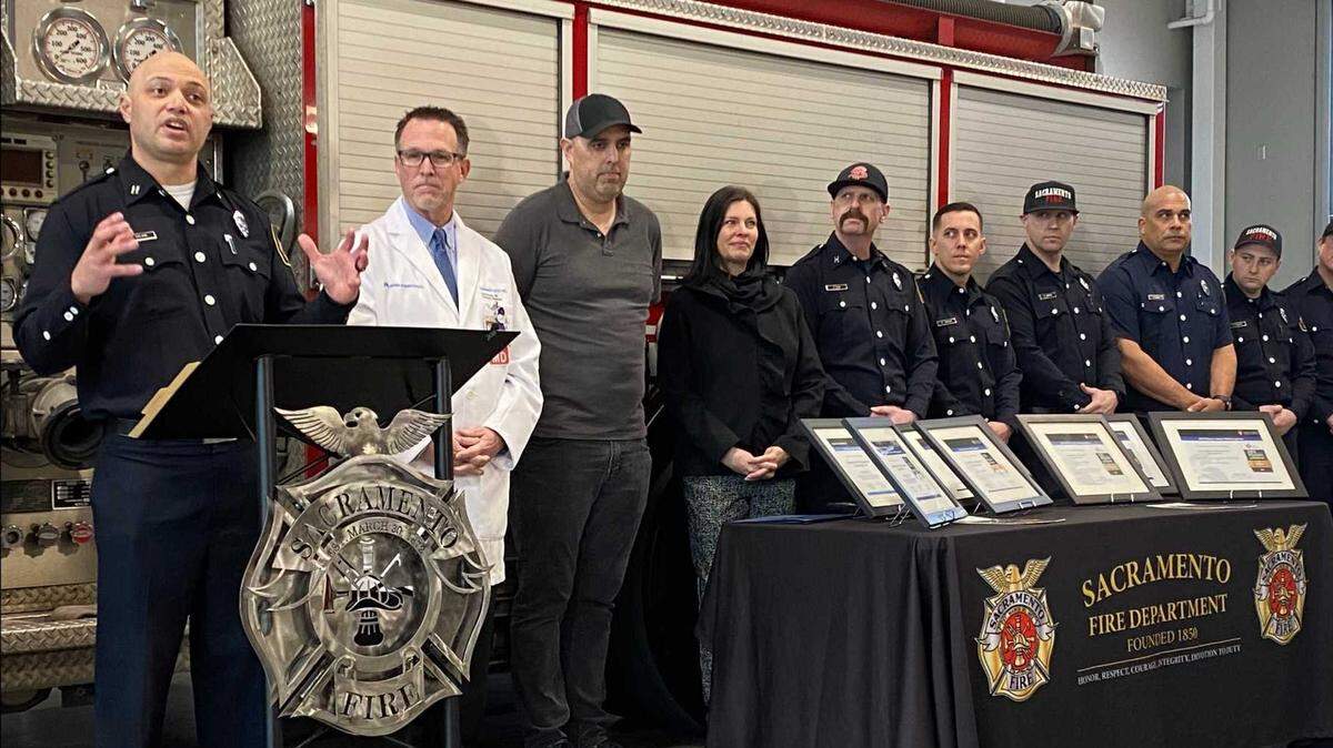 Capt. Justin Sylvia, a Sacramento Fire Department spokesperson, describes the efforts undertaken by firefighters to help save Brett Martin on Dec. 4 at a city river water treatment plant during a Wednesday commendation ceremony at Fire Department Station 14. Martin, third from left, suffered a cardiac emergency while working as a machinist but was saved due to fast actions from firefighters and other city utilities workers. 