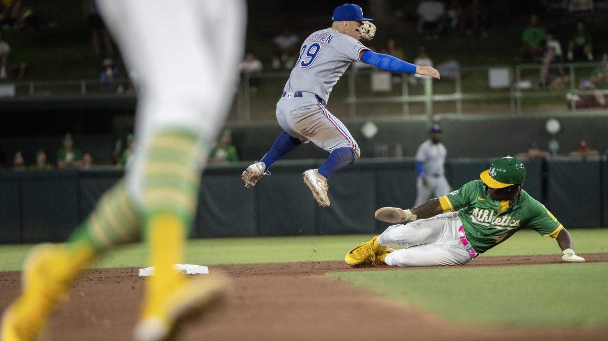 Athletics outfielder Lawrence Butler (4) is forced out at second as Texas Rangers second baseman Cody Freeman (39) shows to first in the fourth inning during a game at Sutter Health Park in West Sacramento on Friday, Aug. 29, 2025.