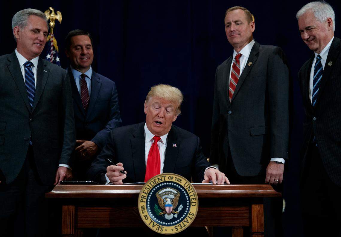President Donald Trump signs an order in October 2018 demanding more flexibility in water deliveries in California. At a ceremony Wednesday in Bakersfield, he finalized the administration’s plan to increase pumping through the Delta.