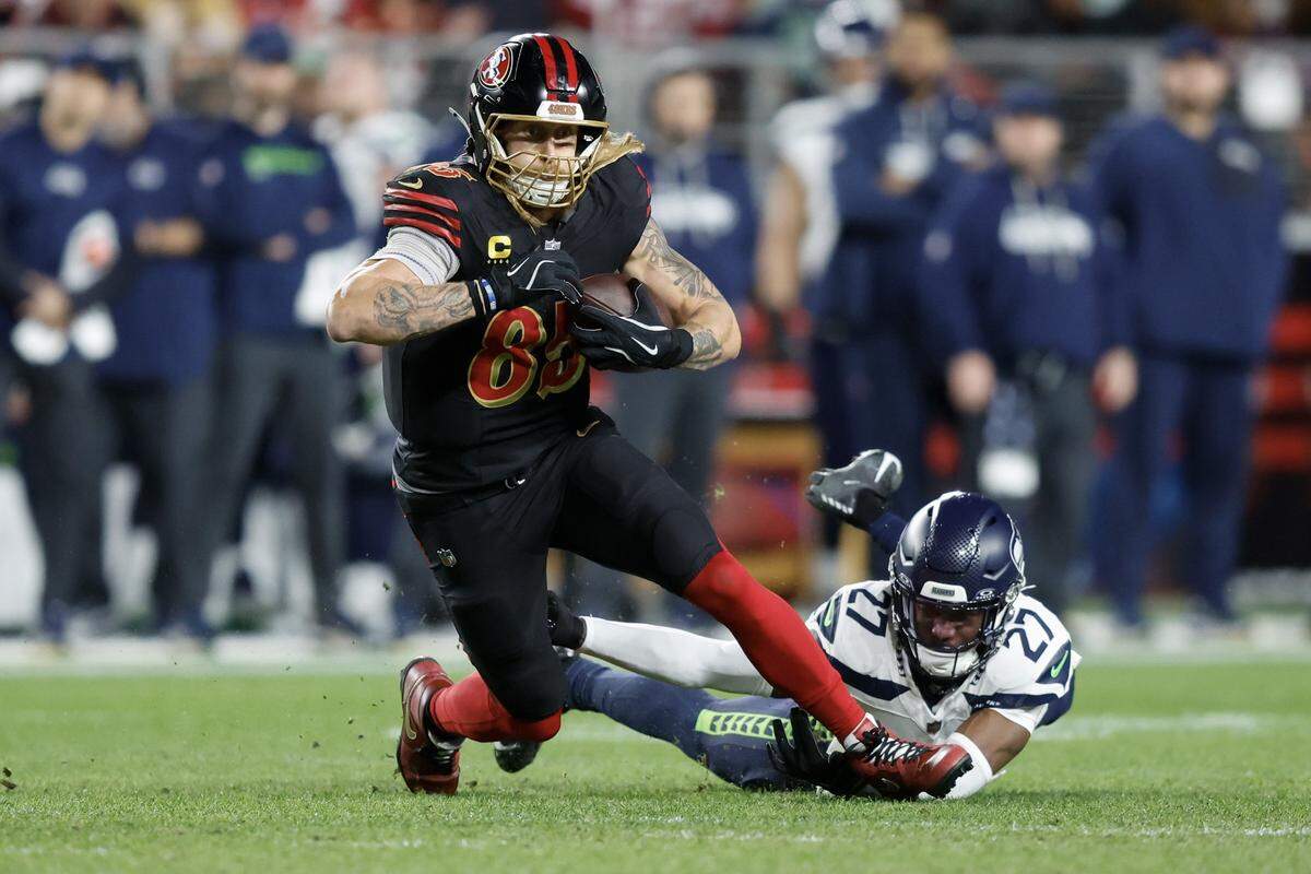 San Francisco 49ers tight end George Kittle breaks a tackle by Riq Woolen of the Seattle Seahawks during the second quarter of a game at Levi's Stadium on Saturday in Santa Clara.