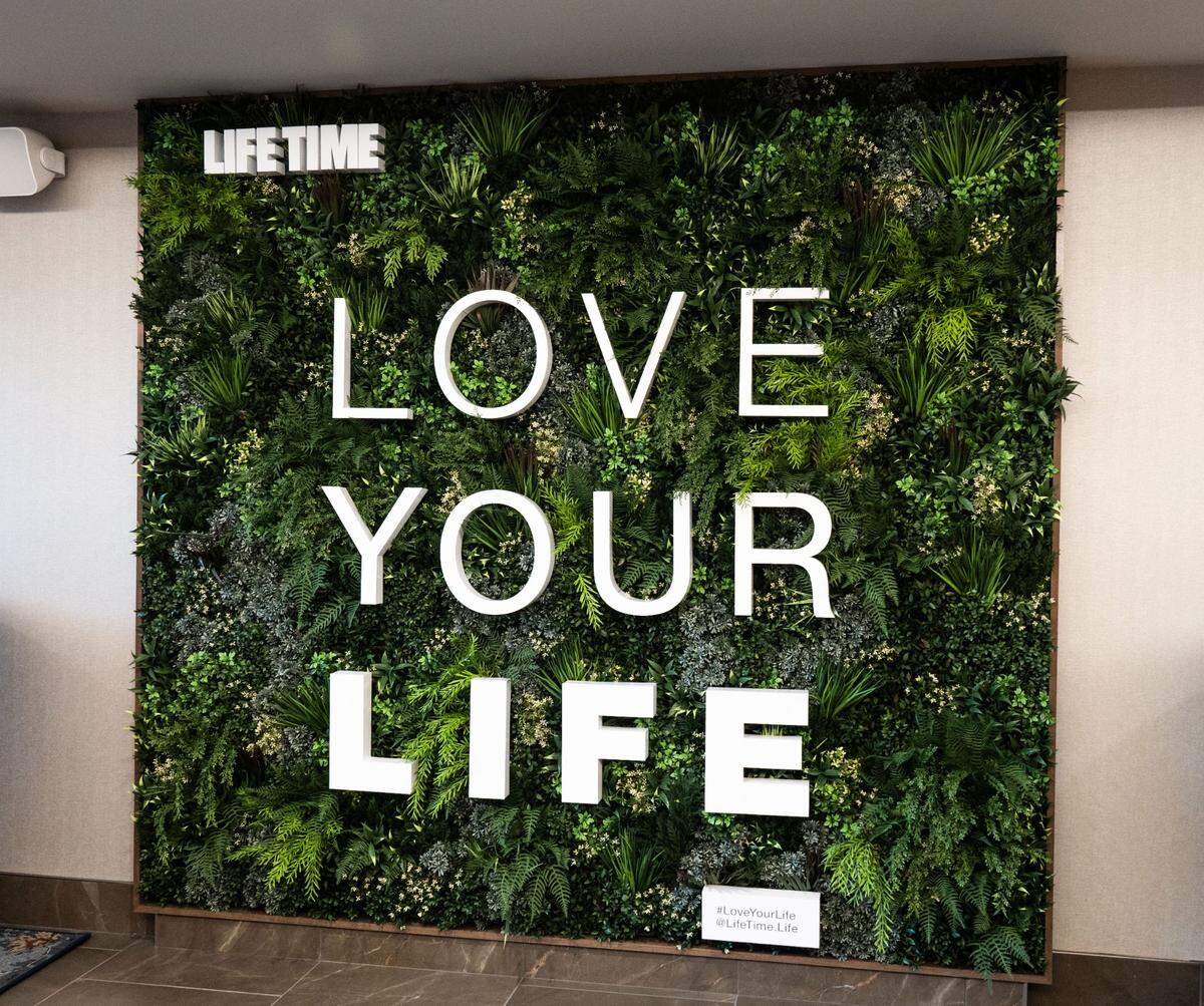 A sign in the entryway reads “Love your life” at Life Time Arden fitness club on Thursday.