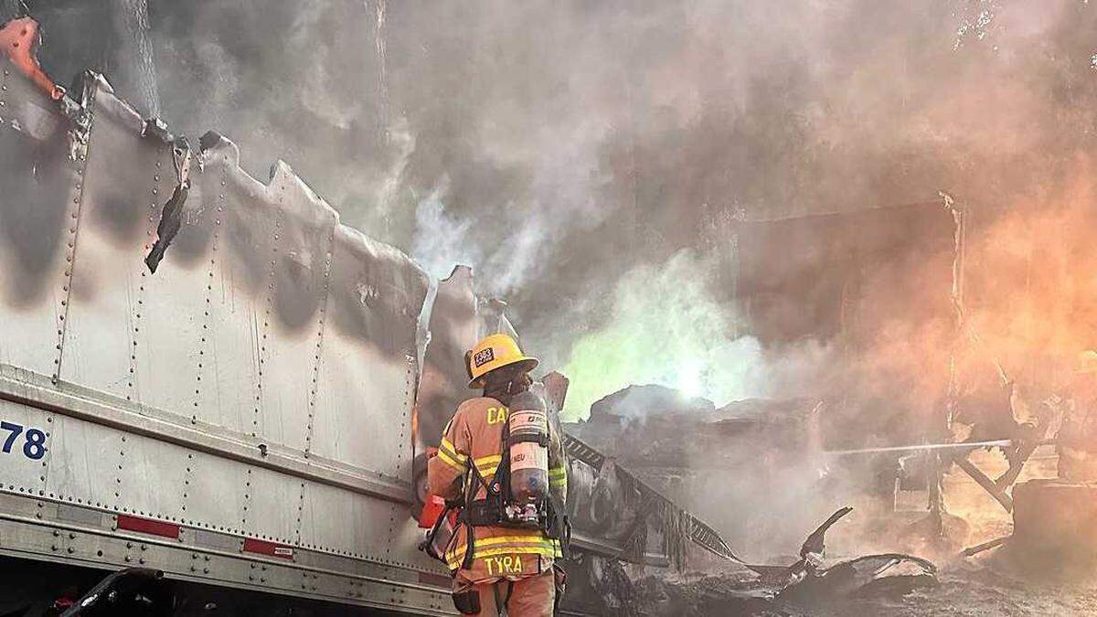 Firefighters mop up a trailer fire involving 40,000 pounds of chocolate on Interstate 80 a few miles north of Colfax on Monday, July 31, 2023. The cause of the fire is under investigation.