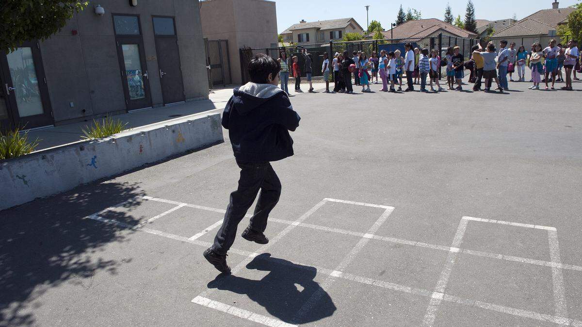 A boy runs to join the line after recess at Heron Elementary School in Natomas in 2011. 