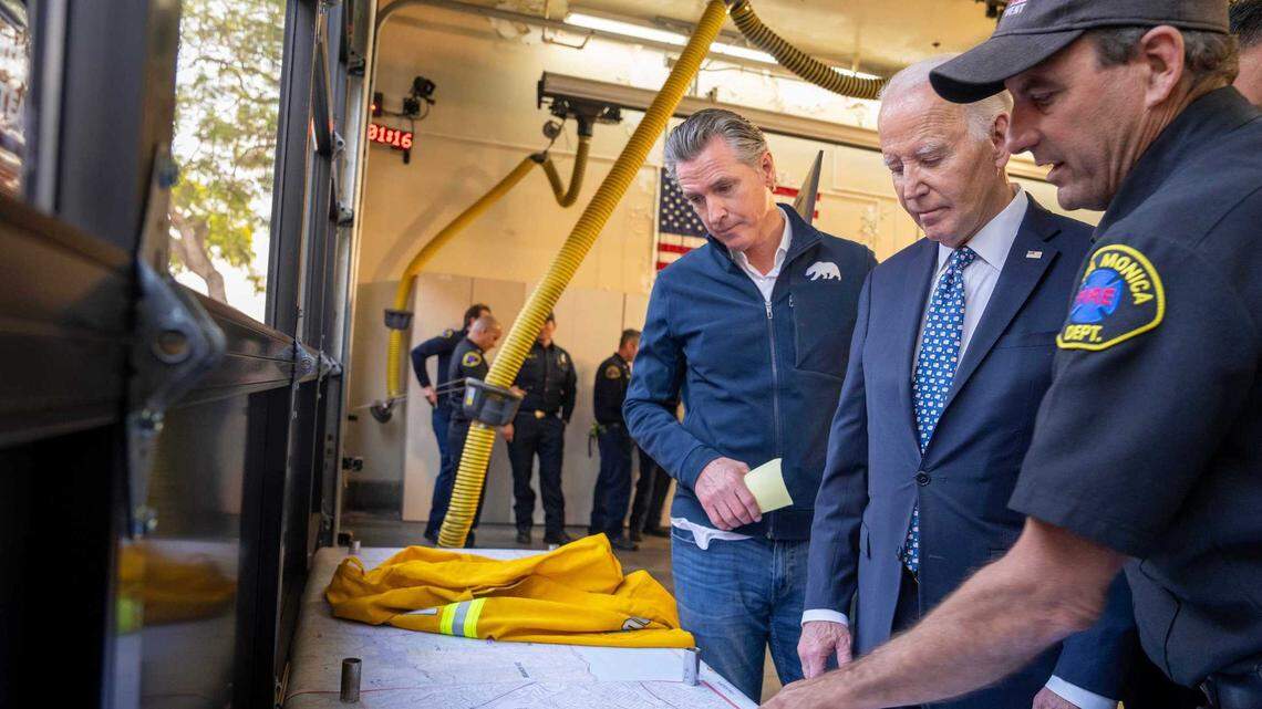 Gov. Gavin Newsom and President Joe Biden are briefed on the Palisades Fire and other blazes in the Los Angeles area at Santa Monica Fire Station No. 5 on Wednesday. Biden has quickly approved California’s request for federal assistance as the blazes destroyed more than 1,000 homes and killed two people.
