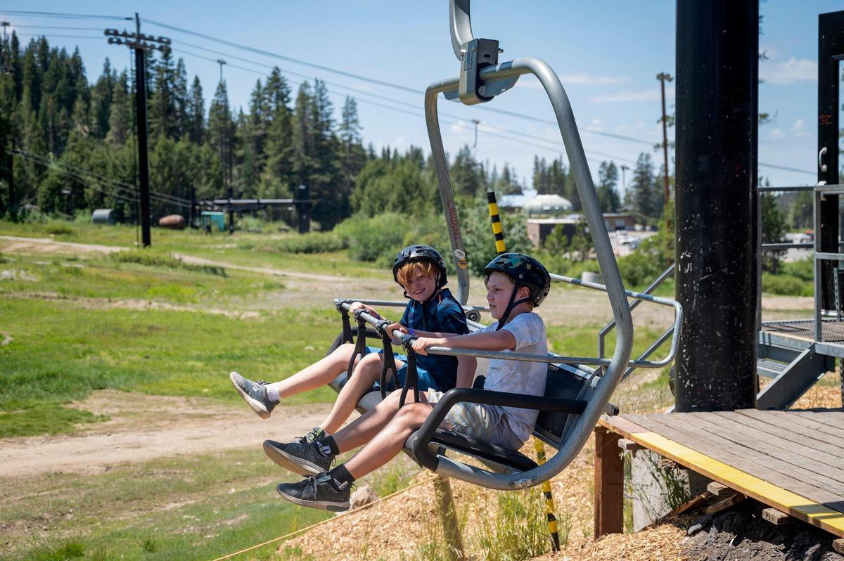 Elliot Davis, left, 10, and his brother Josh, 12, of Danville, ride on the ski lift for the mountain bike trails at Woodward Tahoe summer camp on July 18 at Boreal Mountain Resort in Soda Springs.