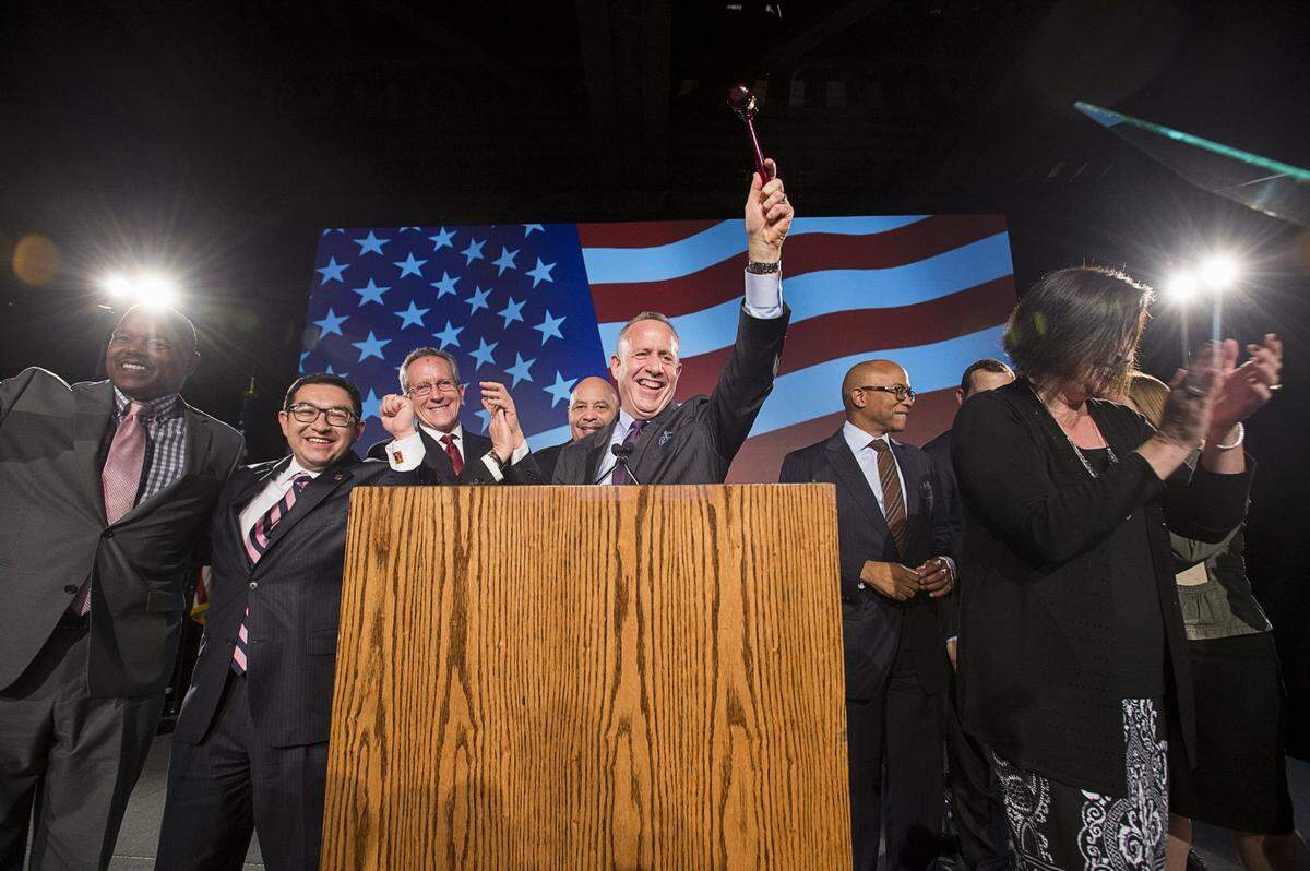 Sacramento Mayor Darrell Steinberg raises the gavel as he stands with City Council members after sworn into office during his inauguration party at the California State Railroad Museum in Sacramento on Dec. 13, 2016.