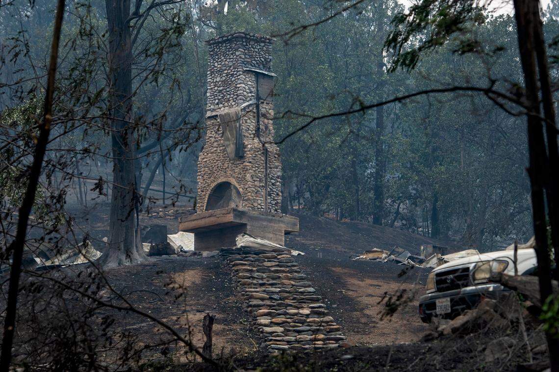 Stairs lead to a house devastated along Highway 96 as the McKinney Fire burns in Klamath National Forest in Siskiyou County on Sunday.