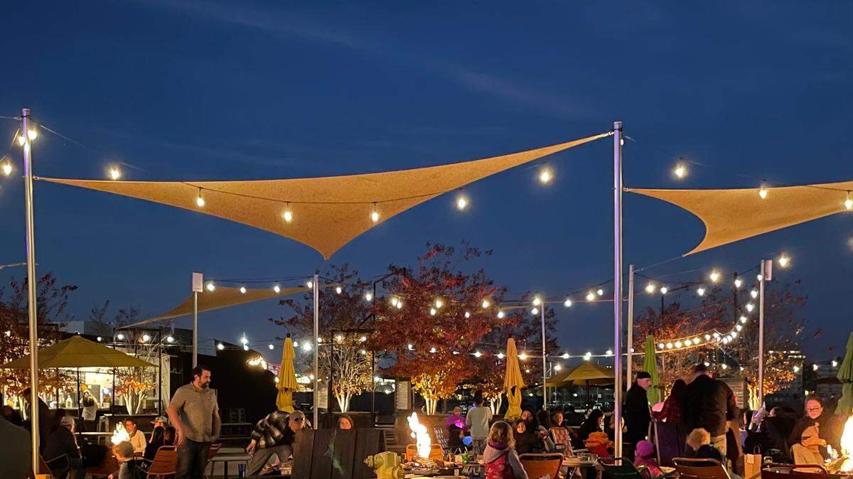 Guests lounge under string lights at Drake’s: The Barn in West Sacramento in 2022. The open-air venue will host R&B and Ribs this Sunday, featuring DJs and food vendors for a day party experience.