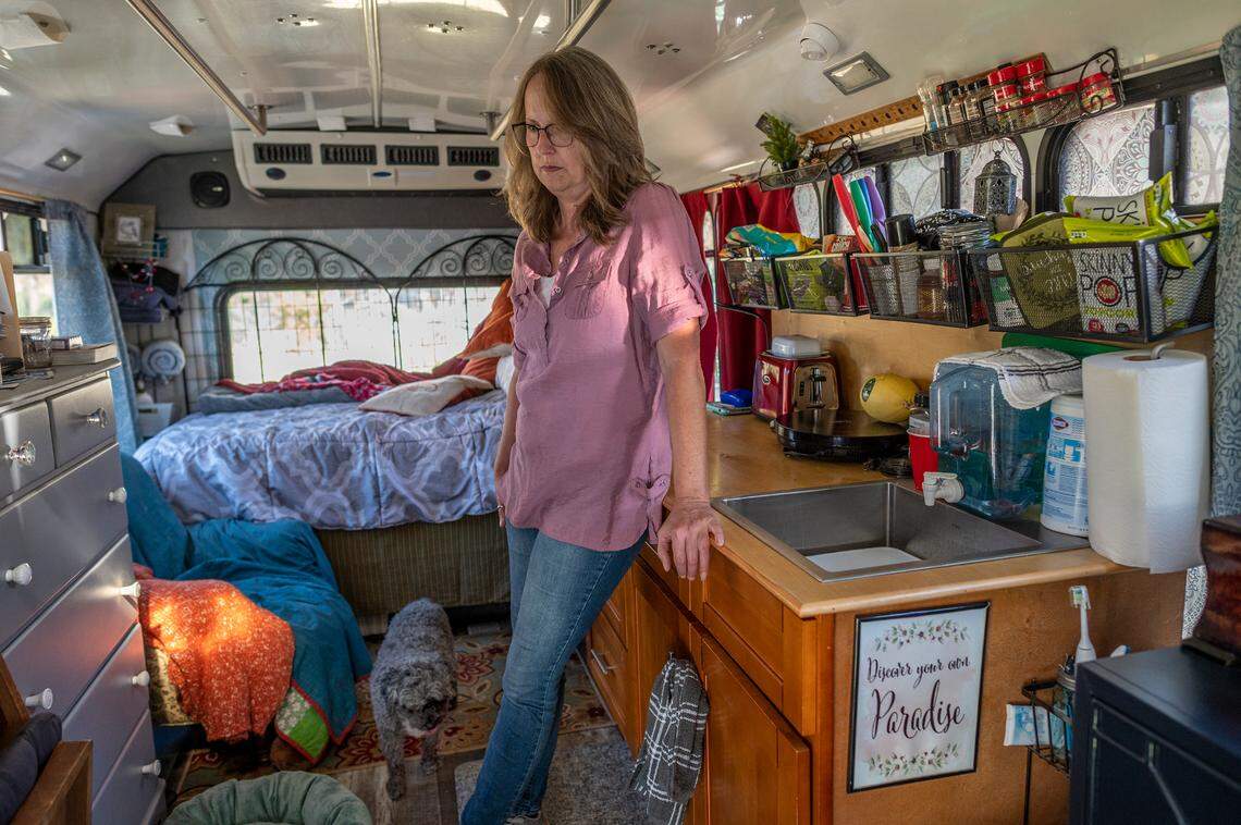 Skeeter Schuette leans against a cabinet in March inside the paratransit bus where she lives in Paradise. “I haven’t seen a television in over three years. I haven’t switched a light switch or walked into a bathroom... I’m tired, really tried,” said Schuette.