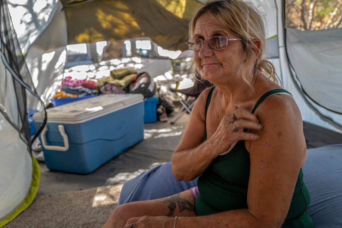 Gwen Mayse fights back tears inside her tent on Aug. 25 as she spoke about the hardship of moving from one place to another and having no hope of ever finding permanent housing in Sacramento.