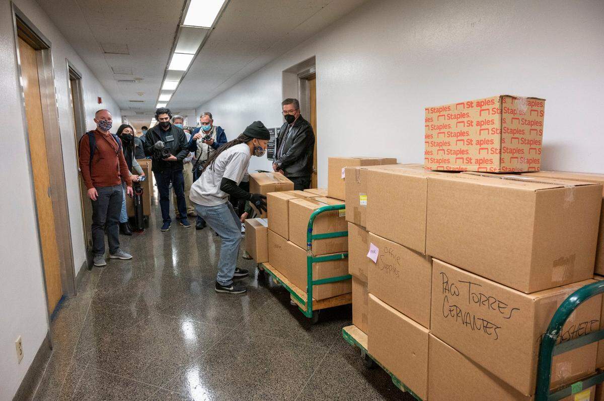 Assemblyman Ken Cooley, chair of the Joint Rules Committee, right, watches as boxes are stacked in the hallway of the Capitol annex as legislators move out Wednesday. Legislators will temporarily be housed in a new office building known as the Swing Space during the construction of the new annex.