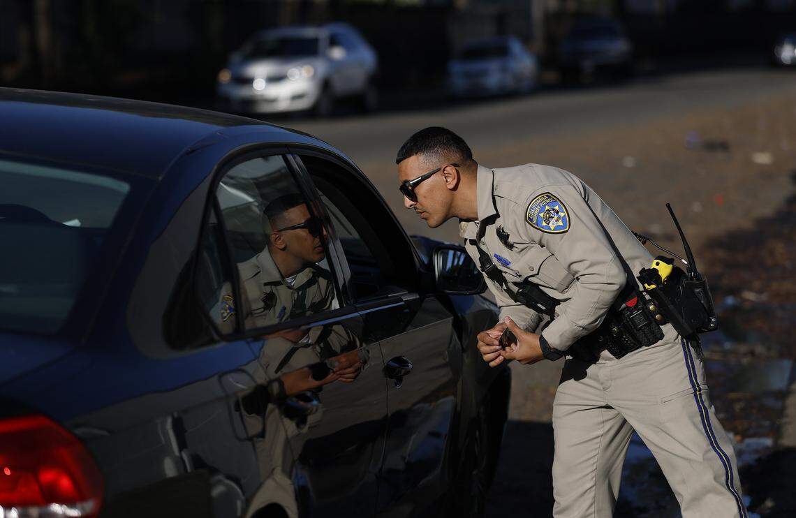 OAKLAND, CALIFORNIA - OCTOBER 16: California Highway Patrol (CHP) officer Adib Zeid talks to a driver during a traffic stop for expired plates on October 16, 2025 in Oakland, California. California Gov. Gavin Newsom is deploying new CHP crime suppression teams to San Diego, Inland Empire, Los Angeles, Central Valley, Sacramento, and the San Francisco Bay Area following successful efforts already underway in Oakland, Bakersfield, and San Bernardino. The CHP crime suppression units provide critical support to local law enforcement by targeting and eliminating illegal activity in high-crime areas. Since Gov. Newsom first deployed CHP officers in April 2024, officers have made over 9,000 arrests, recovered nearly 5,800 stolen vehicles, and confiscated more than 400 firearms. (Photo by Justin Sullivan/Getty Images)