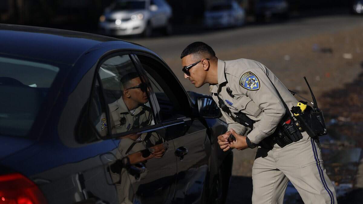 OAKLAND, CALIFORNIA - OCTOBER 16: California Highway Patrol (CHP) officer Adib Zeid talks to a driver during a traffic stop for expired plates on October 16, 2025 in Oakland, California. California Gov. Gavin Newsom is deploying new CHP crime suppression teams to San Diego, Inland Empire, Los Angeles, Central Valley, Sacramento, and the San Francisco Bay Area following successful efforts already underway in Oakland, Bakersfield, and San Bernardino. The CHP crime suppression units provide critical support to local law enforcement by targeting and eliminating illegal activity in high-crime areas. Since Gov. Newsom first deployed CHP officers in April 2024, officers have made over 9,000 arrests, recovered nearly 5,800 stolen vehicles, and confiscated more than 400 firearms. (Photo by Justin Sullivan/Getty Images)