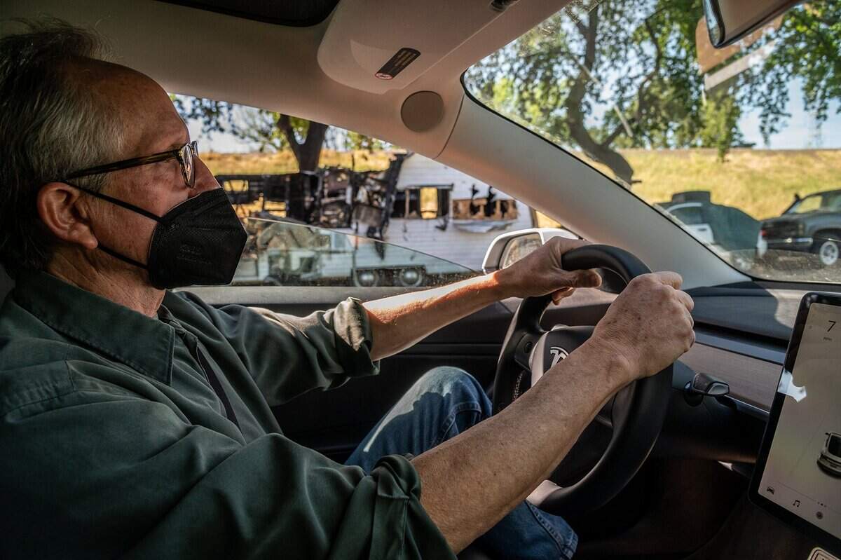 Sacramento City Councilman Jeff Harris drives in his Tesla past a burnt motor home on Lathrop Way on April 29. “I represent the owner of that business and I represent the person in that camper over there. If they are in my district, then they are my constituent and as a council member I’m looking out hopefully for everybody’s best interest,” he said.