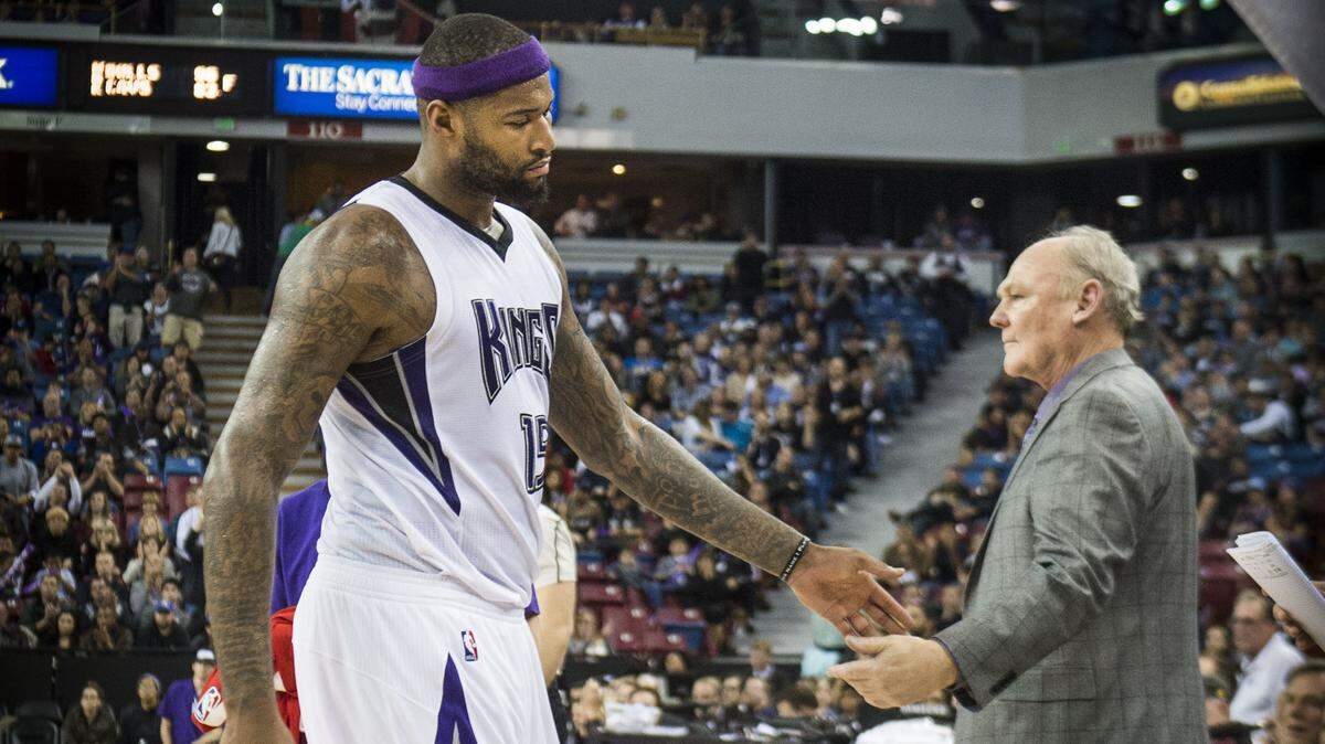 Sacramento Kings center DeMarcus Cousins (15) reaches for the hand of Sacramento Kings head coach George Karl as Kings defeat the Indiana Pacers in 2016.