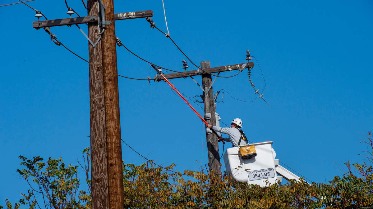 A SMUD technician works on a power line on Oct. 26, 2019.