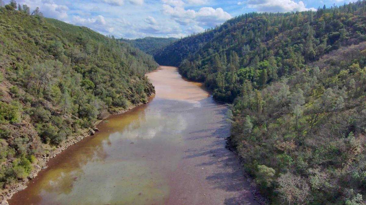 An aerial view shows the Yuba River where it meets Englebright Lake along the Nevada and Yuba County line near Dobbins on Sunday, Feb. 15, 2026. A crew from the California Department of Fish and Wildlife and Office of Spill Prevention and Response is investigating an oil sheen reported after Friday’s water pipe rupture at the New Colgate Powerhouse.