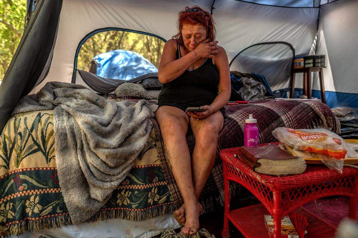 Twana James breaks down in tears as she checks her bank account on her phone and realizes she did not receive the social security check she was expecting. She was planning to use the money to buy water and food for the seniors at the camp. “Everybody’s depending on me,” she cried.