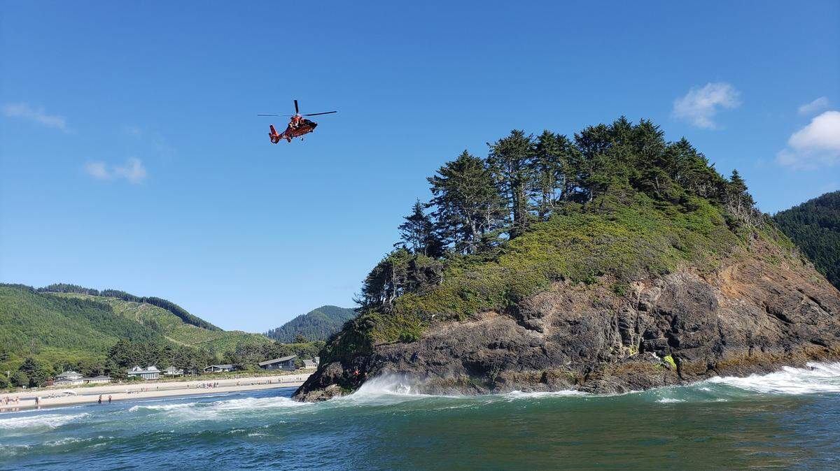 A U.S. Coast Guard helicopter rescued an 18-year-old man who became stuck on Proposal Rock and a bystander who tried to help in Oregon.