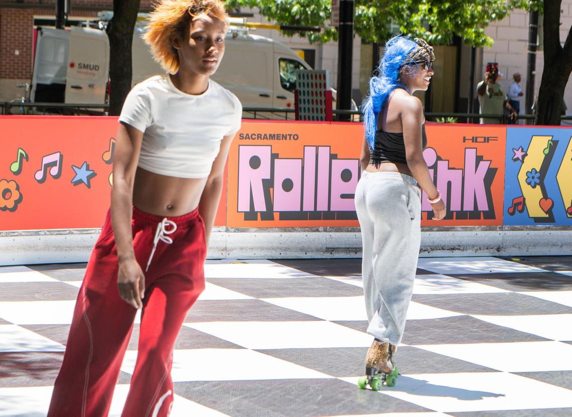 Aniyah Bufford, 17, left, and Karieda Scott, 16, chat with one another while roller skating at the Downtown Roller Rink in downtown Sacramento’s Ali Youssefi Square on Friday, June 28, 2024. Bufford said she enjoys skating becuase it is calm, peaceful and helps her clear her mind.