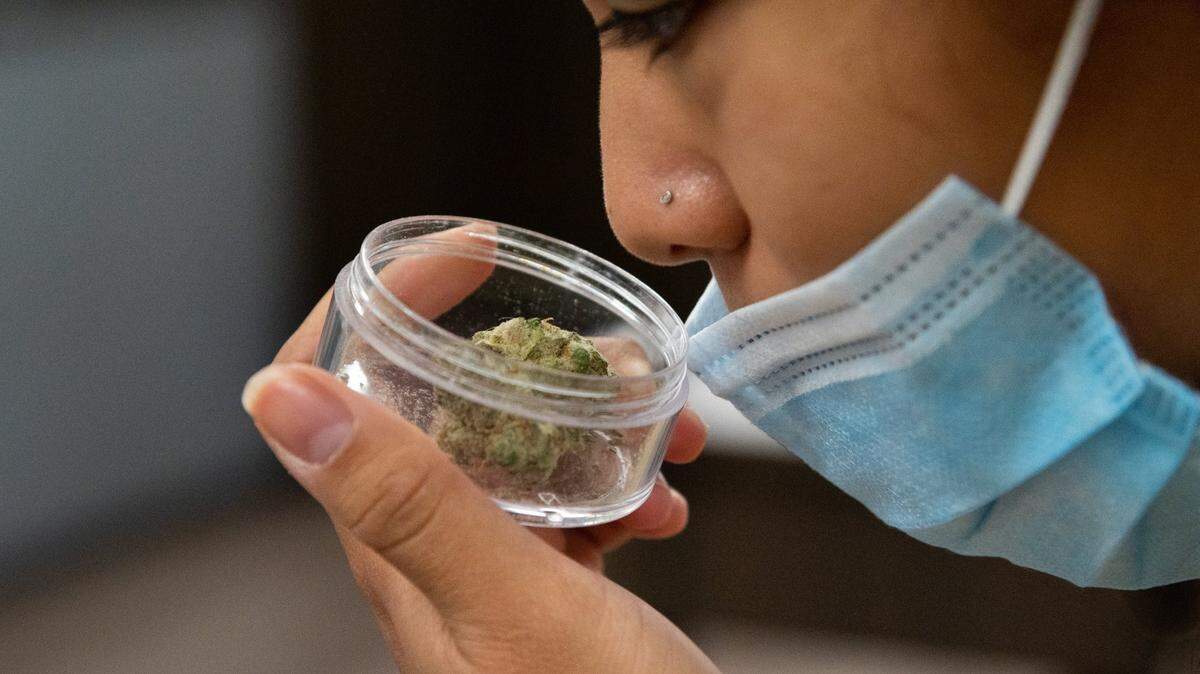 Tina Duenas breathes in the aroma of marijuana available for sale at the Perfect Union marijuana dispensary on Friday, October 22, 2021, in Sacramento.