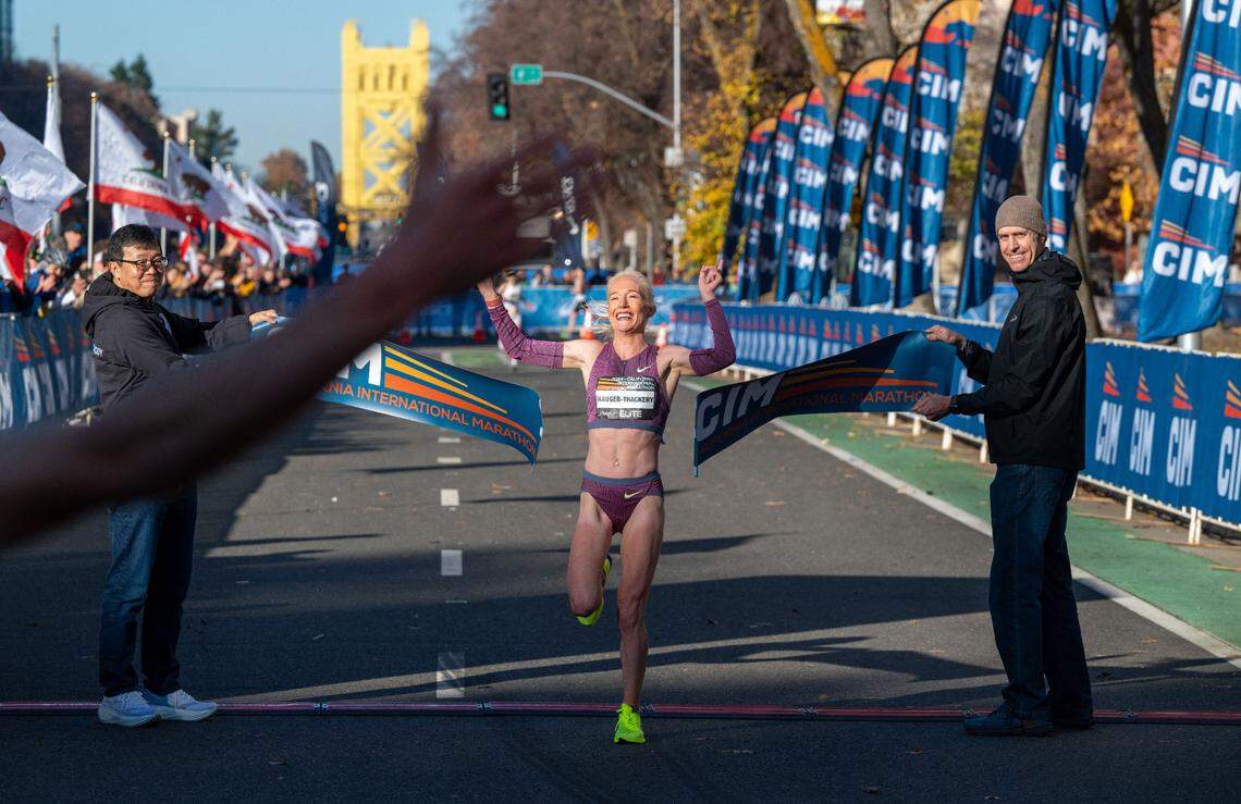British Olympian Callie Hauger-Thackery smiles as she wins the women’s California International Marathon title on Sunday and sees her husband and coach Nick Hauger, who finished third on the men’s side moments earlier.